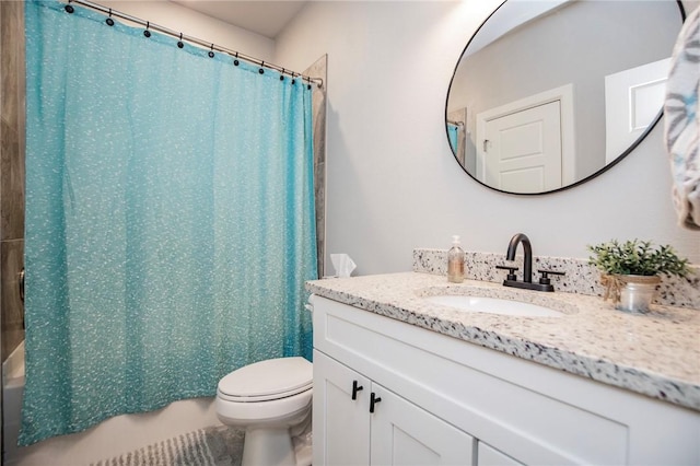 bathroom featuring toilet, shower / tub combo with curtain, and vanity