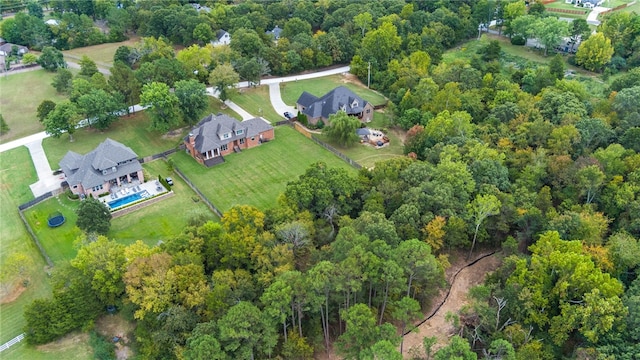 birds eye view of property with a view of trees