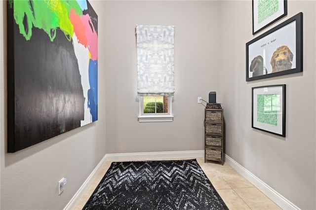 interior space featuring baseboards and tile patterned floors