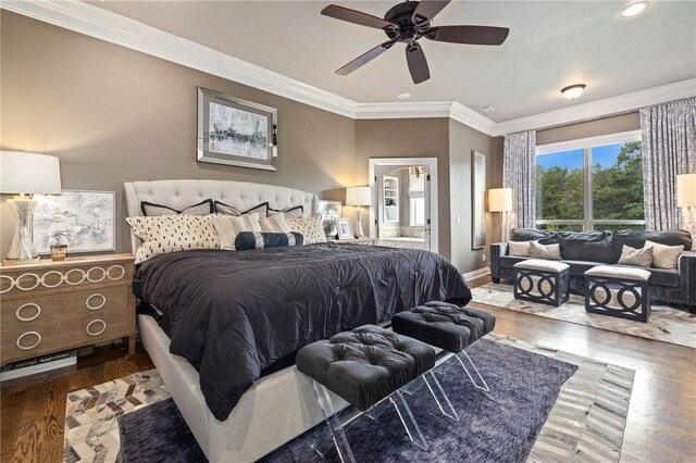 bedroom featuring connected bathroom, wood finished floors, a ceiling fan, baseboards, and crown molding