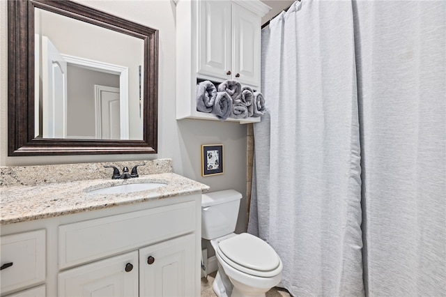 full bathroom featuring toilet and vanity