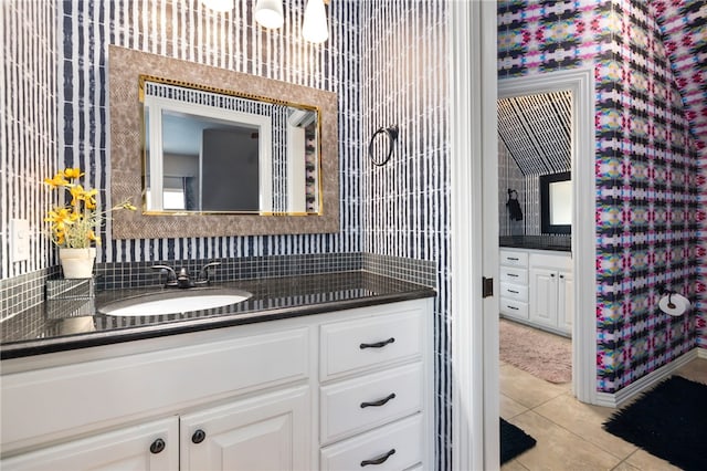 bathroom with tasteful backsplash, vanity, and tile patterned floors