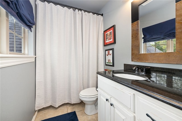 bathroom featuring a shower with shower curtain, vanity, toilet, and tile patterned floors