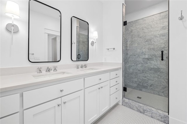 bathroom with double vanity, a sink, and a shower stall