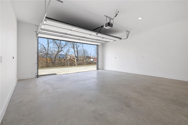 garage with a garage door opener and baseboards