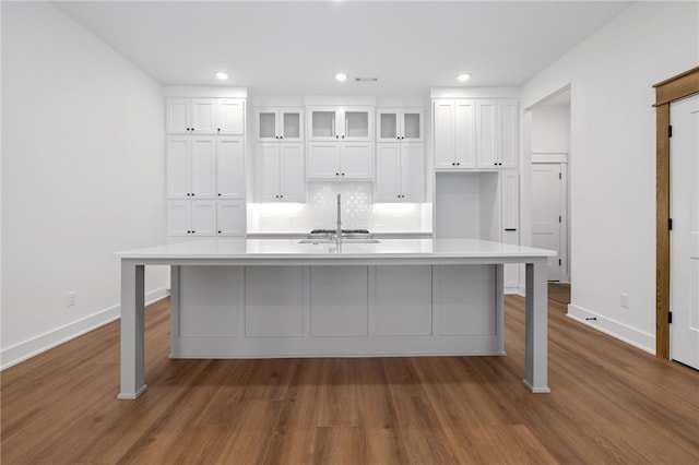 kitchen with dark wood-style floors, light countertops, and white cabinets