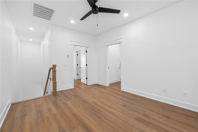 empty room featuring baseboards, visible vents, ceiling fan, wood finished floors, and recessed lighting