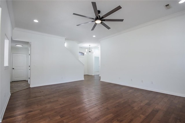 spare room with ceiling fan with notable chandelier, dark wood-style flooring, baseboards, and crown molding