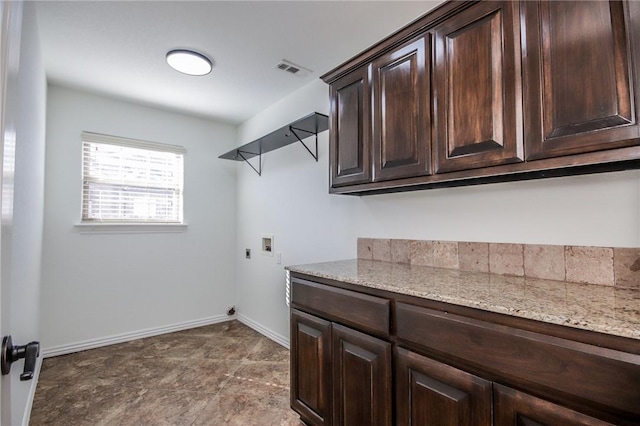 laundry room featuring cabinet space, baseboards, visible vents, hookup for a washing machine, and hookup for an electric dryer