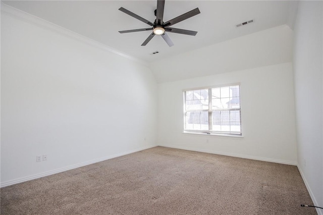 unfurnished room featuring visible vents, a ceiling fan, carpet flooring, vaulted ceiling, and baseboards