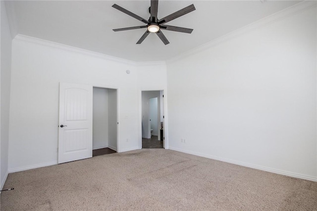 unfurnished bedroom featuring carpet flooring, crown molding, baseboards, and ceiling fan