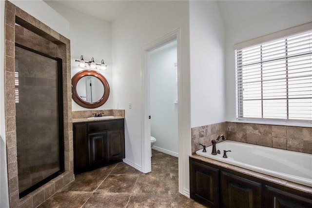 full bathroom with toilet, a shower stall, a wealth of natural light, and a bath