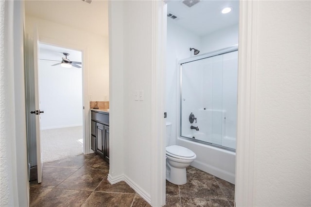 bathroom with toilet, baseboards, combined bath / shower with glass door, and vanity