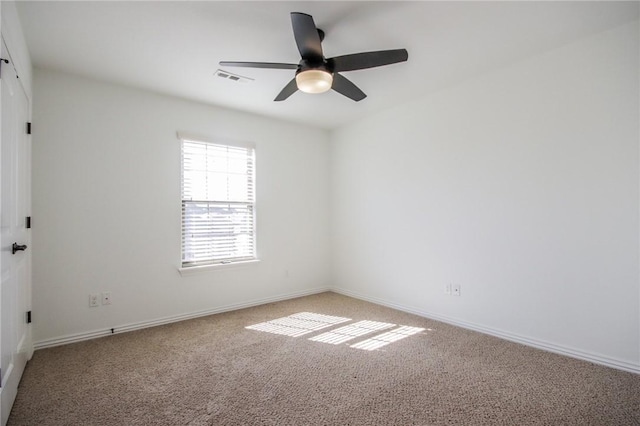 unfurnished room featuring ceiling fan, visible vents, baseboards, and light colored carpet