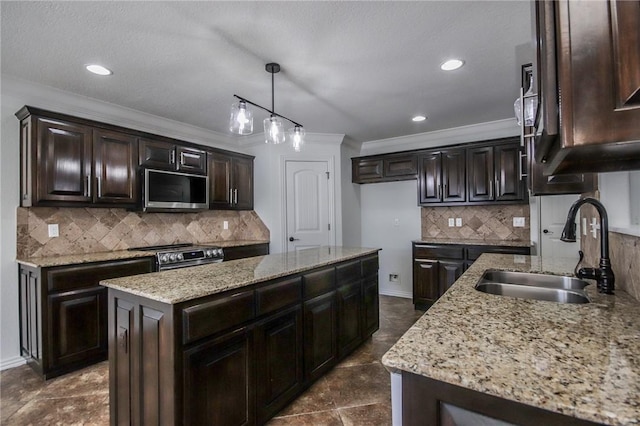 kitchen featuring light stone counters, crown molding, appliances with stainless steel finishes, a sink, and dark brown cabinetry