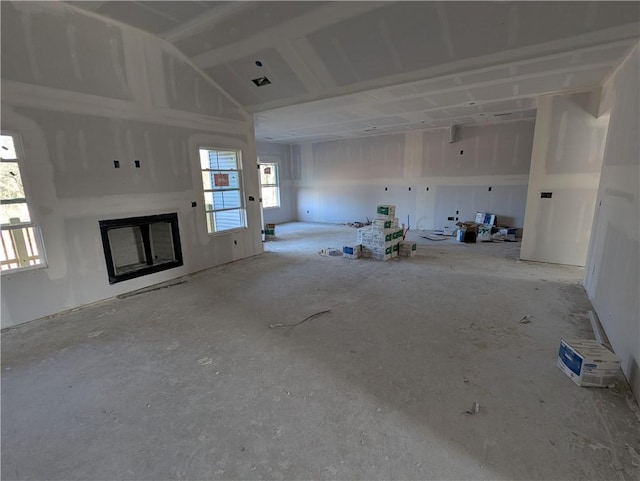 unfurnished living room featuring lofted ceiling and a fireplace