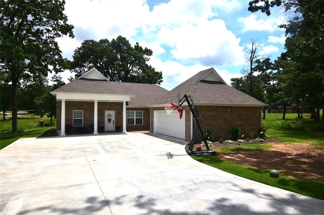 view of front of house featuring a garage, driveway, and brick siding