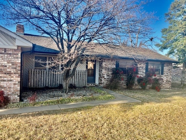 single story home with a front lawn and brick siding