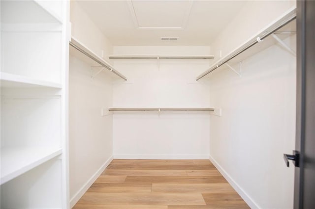 spacious closet featuring light wood-style floors and visible vents