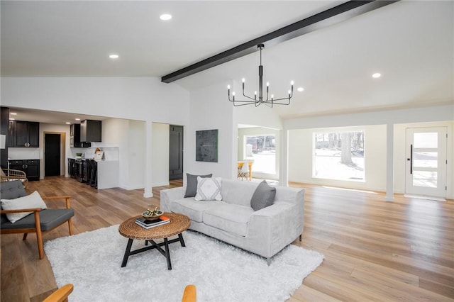 living area with light wood finished floors, baseboards, vaulted ceiling with beams, a notable chandelier, and recessed lighting