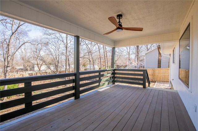 wooden terrace featuring ceiling fan