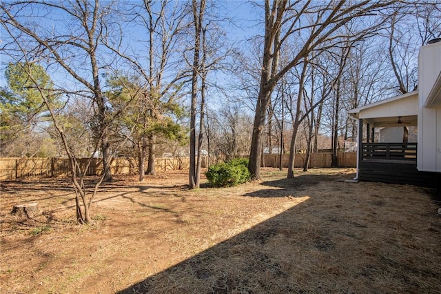 view of yard with a fenced backyard and a ceiling fan