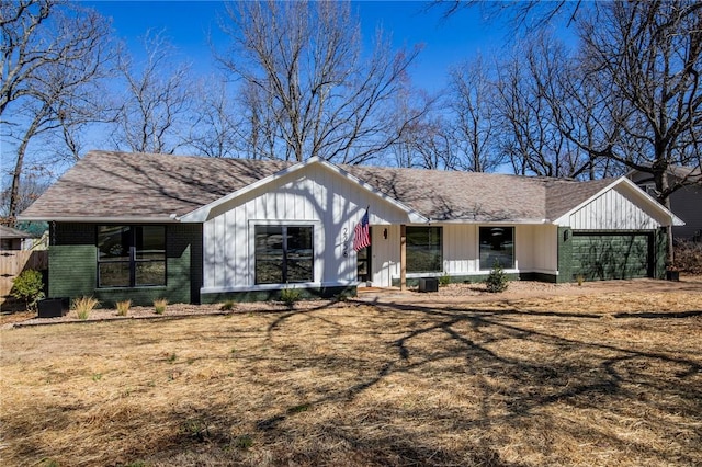 view of front of property with brick siding, roof with shingles, and an attached garage