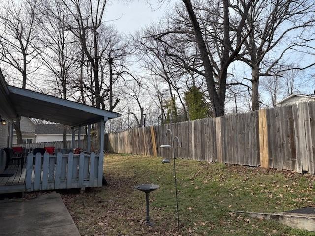 view of yard featuring a fenced backyard and a wooden deck