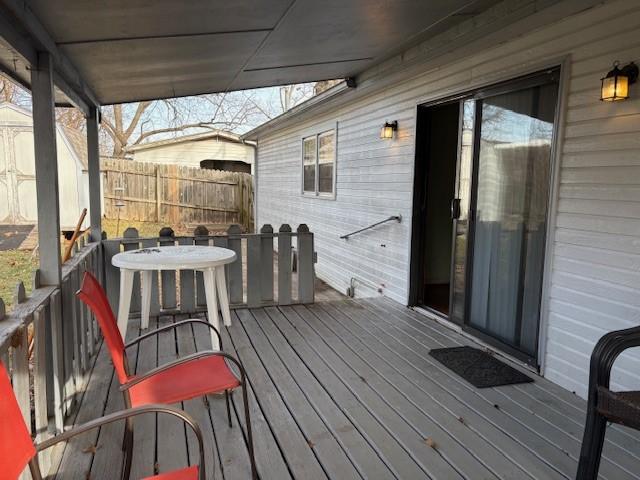 wooden terrace featuring fence