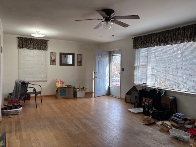 misc room featuring wood finished floors and a ceiling fan