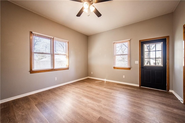 foyer entrance with ceiling fan, baseboards, and wood finished floors