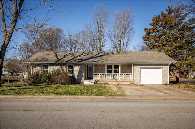 single story home featuring driveway, a garage, a porch, a front lawn, and brick siding