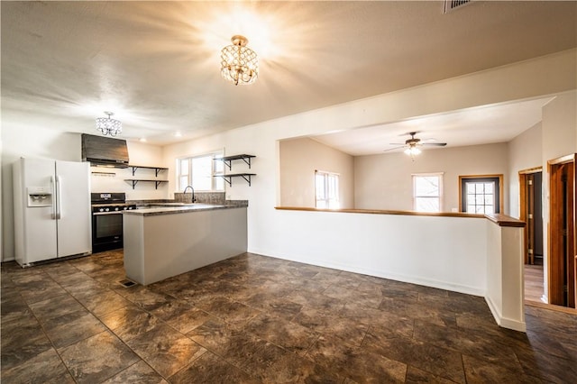 kitchen featuring baseboards, stove, a peninsula, white fridge with ice dispenser, and open shelves