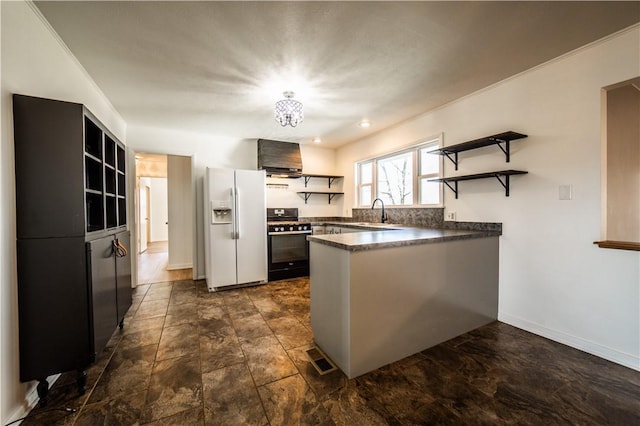 kitchen with a peninsula, white fridge with ice dispenser, gas stove, open shelves, and dark countertops