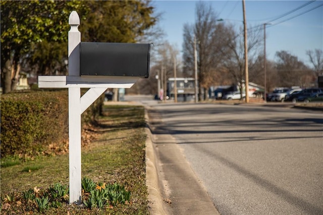 view of street with street lights and curbs