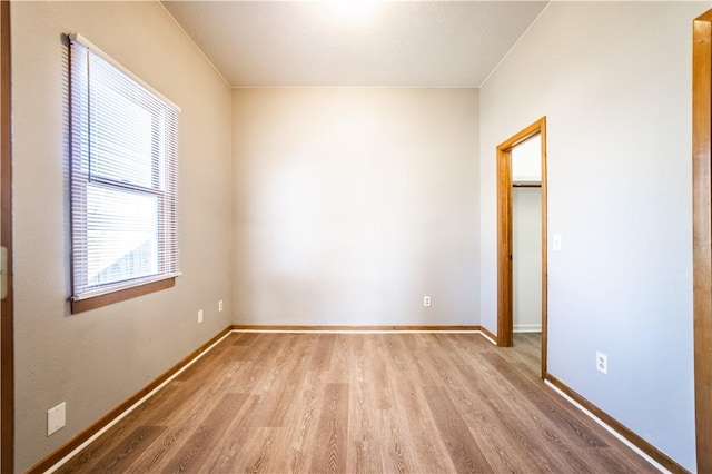 unfurnished room featuring wood finished floors and baseboards