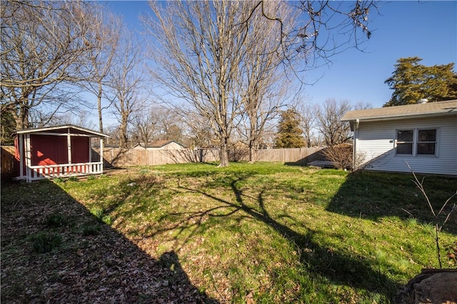 view of yard with an outdoor structure and a fenced backyard