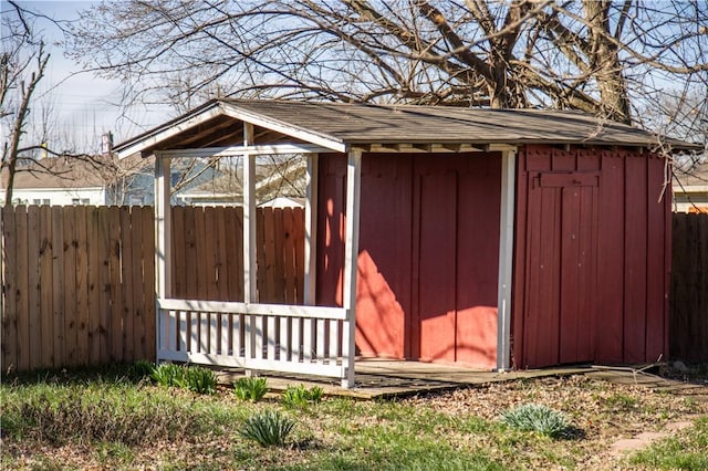 view of shed featuring fence