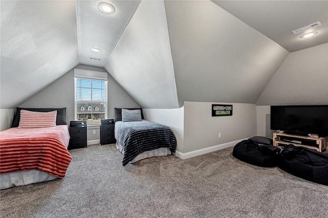 carpeted bedroom with baseboards, visible vents, and vaulted ceiling