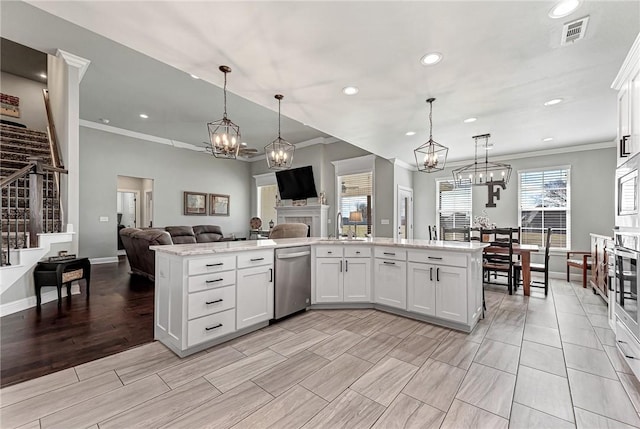 kitchen featuring a notable chandelier, visible vents, white cabinets, open floor plan, and appliances with stainless steel finishes