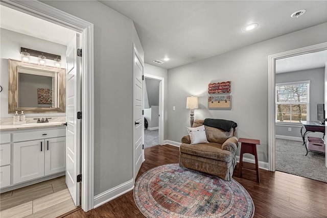 sitting room with baseboards, recessed lighting, visible vents, and light wood-style floors