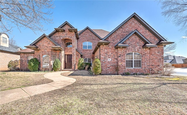 view of front of house featuring a front yard and brick siding