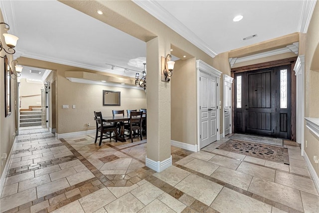 entrance foyer featuring visible vents, stairs, baseboards, and ornamental molding