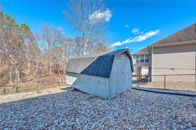 view of shed featuring fence