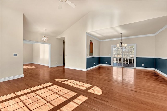 spare room featuring high vaulted ceiling, baseboards, wood finished floors, and ceiling fan with notable chandelier