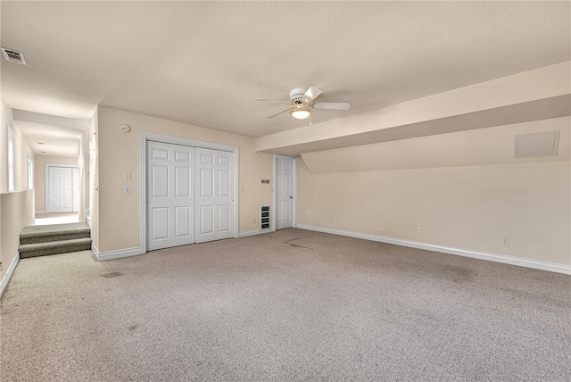 unfurnished bedroom featuring carpet floors, a closet, visible vents, ceiling fan, and baseboards