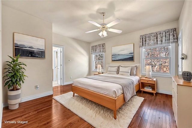 bedroom with ceiling fan, baseboards, and hardwood / wood-style flooring