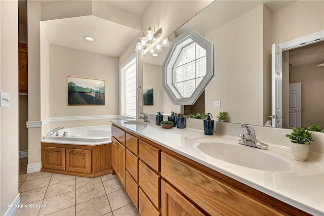 full bath featuring double vanity, a sink, a bath, and tile patterned floors