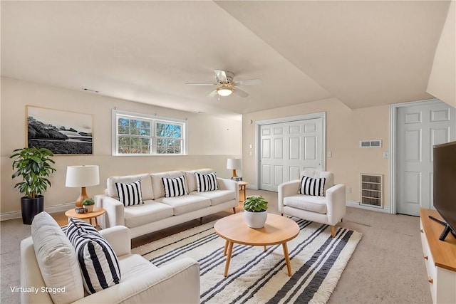 living area with a ceiling fan, light colored carpet, visible vents, and baseboards