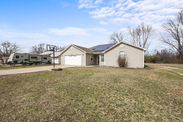 ranch-style home featuring a garage, driveway, a front lawn, and solar panels